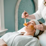 An esthetician performing an upper lip wax in St. Augustine.